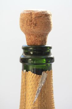 Close up of a champagne cork popping out of a bottle