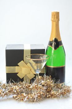 Gift box, champagne cocktail glass and a bottle of champagne