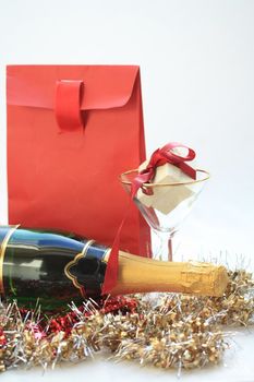 Red christmas gifts and a bottle of champagne