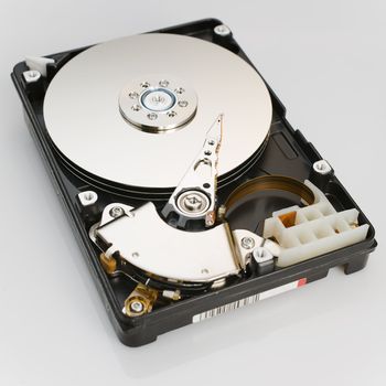 Modern opened hard disk drive over a white surface