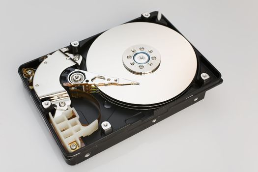 Modern opened hard disk drive over a white surface
