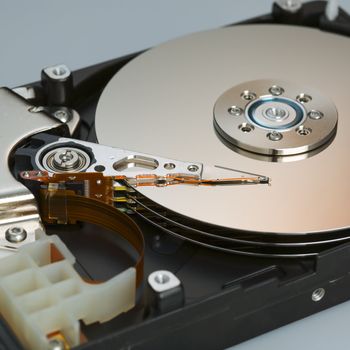 Modern opened hard disk drive over a white surface