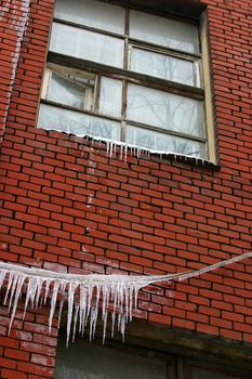 Frozen window on a red brick wall