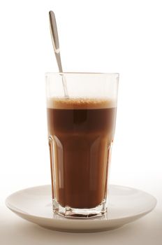 Glass of Hot chocolate with foam and spoon