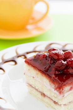Piece of raspberry cake on the plate with chocolate dressing