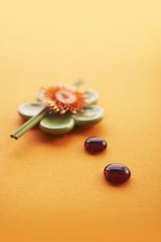 Incense sticks on the orange table with glass stones