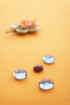Incense sticks on the orange table with glass stones