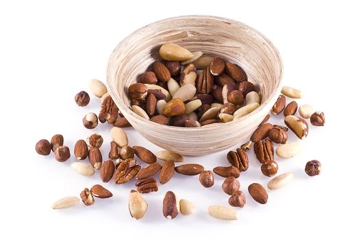 Wooden bowl with different kinds of nuts; isolated on white.