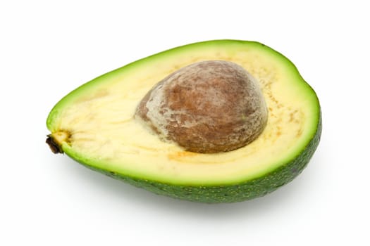 Half avocado with stone on a white background