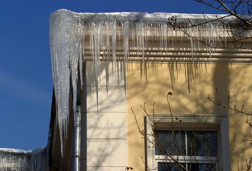 The big icicles on a roof of a building