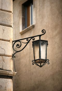 Street lantern on a background of a wall