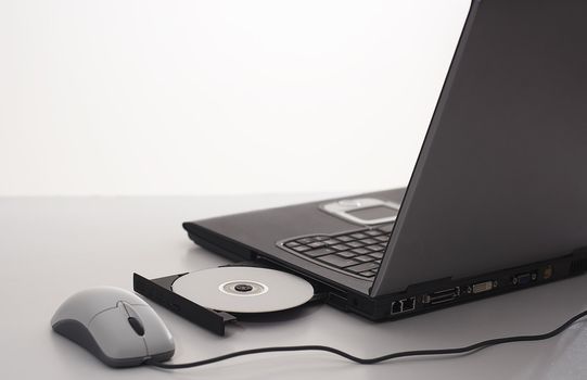 Laptop with mouse and cd-r disk