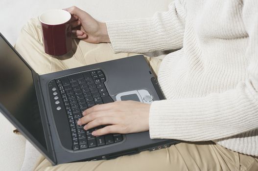 Woman sitting on the couch with laptop