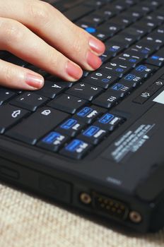 Woman typing with laptop