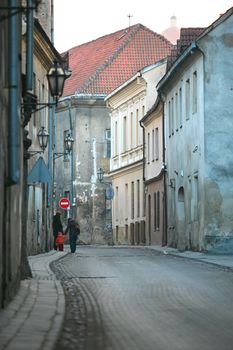 Two adult women and the small child go on old city