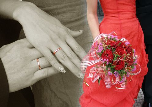 The fiance and the bride has wedding rings on their hands. There is wedding bouquet of the white roses in the hands of bride. 