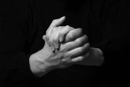 Two man's hands on a dark background