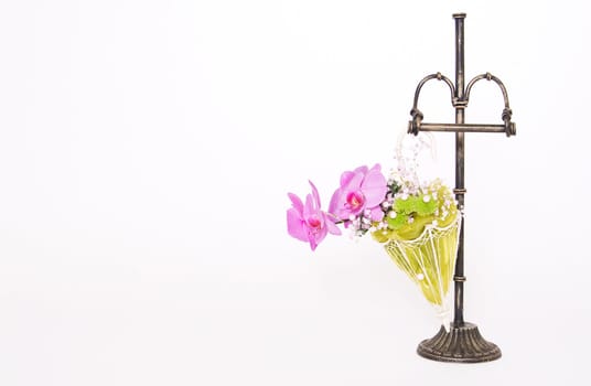 Decoration with orchid in small umbrella and metal stand