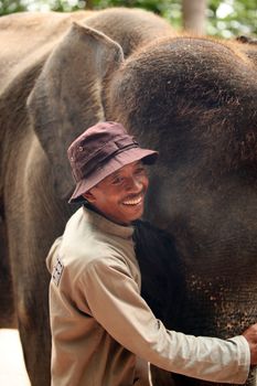 The big elephant and man. Bali zoo. Indonesia