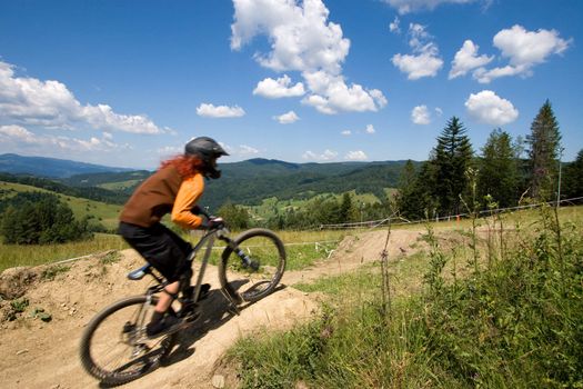 Female mtb biker during downhill event