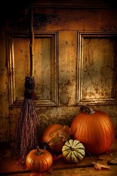 Halloween night/ Pumpkins, broom and gourds at the door ready for halloween