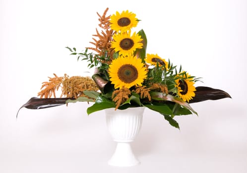 Summer decoration with sunflowers and green leafs