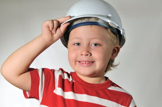 The boy shows, as the daddy dresses a working helmet 
