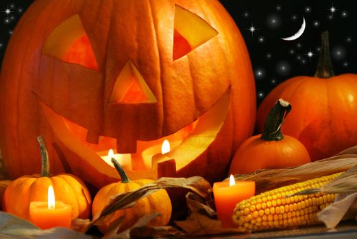 Scarved pumpkin with candles and corn