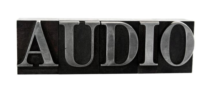 old metal letterpress letters form the word 'audio isolated on white