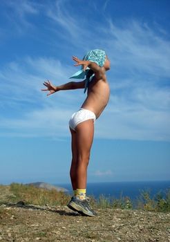 Small the girl on a background of the sky