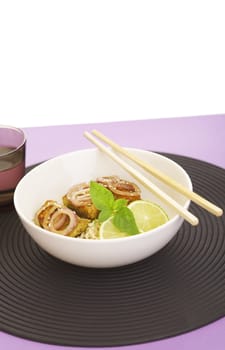 Asian style noodles and deep fried fish on purple background