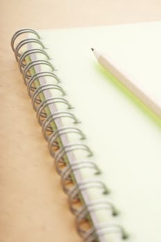 Pencil on the green spiral notebook cover