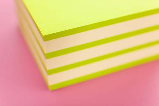 Pile of sticky notes over a pink table