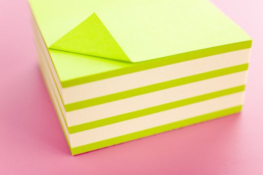 Pile of sticky notes over a pink table