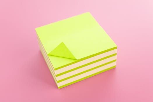 Pile of sticky notes over a pink table