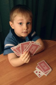 The little boy with cards in hands