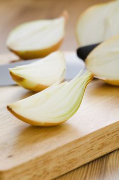 Onion halves with knife on the table 