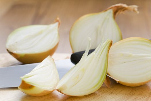 Onion halves with knife on the table