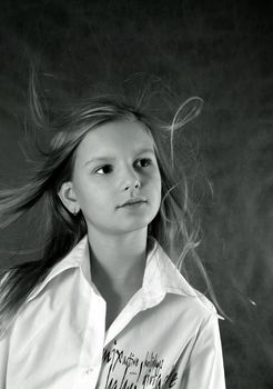 Portrait of the girl close-up with developing hair. b/w+blue tone