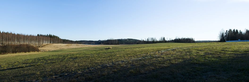 Panorama image from frozen field on late of autumn
