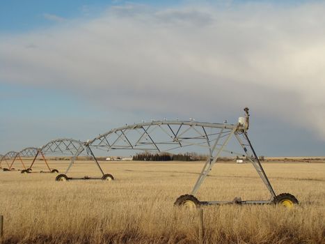 large irrigation system runs across a prairie field