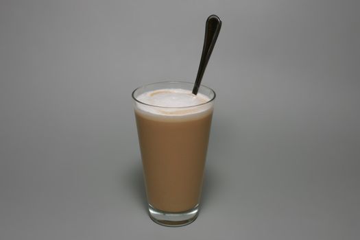 Coffee latte with whipped cream in glass.