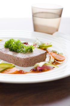Gourmet game P�t� with vegetables and jam on the table