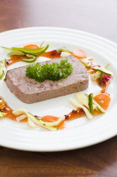 Gourmet game P�t� with vegetables and jam on the table