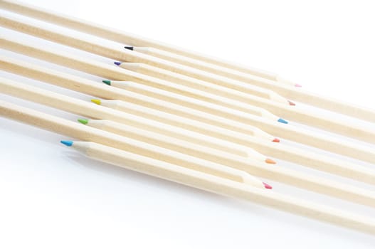 Line of colored pencils isolated on white background