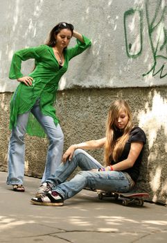 The girl with a roller board and the beautiful woman