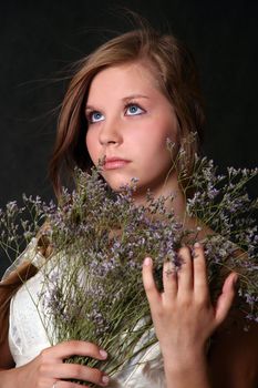 The girl with a bouquet from field flowers
