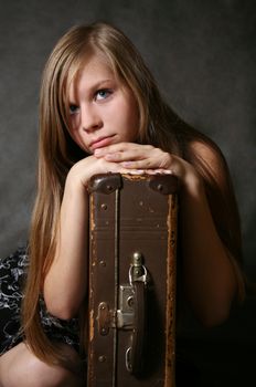 Portrait of the young girl with a suitcase