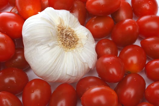 Garlic surrounded by cherry tomatoes. Look at my gallery for more fresh fruits and vegetables.
