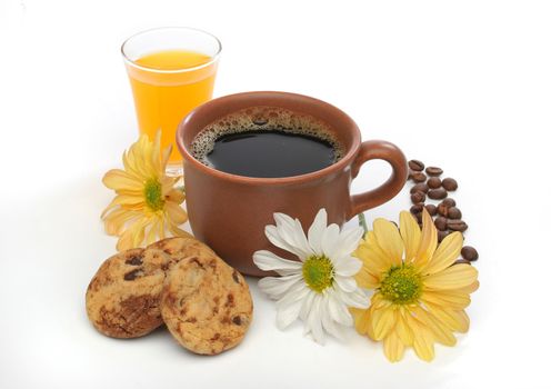 A beautiful coffee breakfast with cookies, orange juice, coffee beans and flowers.  Look at my gallery for more delicious meals